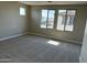 Comfortable bedroom features plush carpeting, and large windows with neighborhood views at 3363 S 180Th Ln, Goodyear, AZ 85338