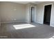 Bedroom featuring neutral carpet, outlets for wall mounting a TV, and closet with shelving at 3363 S 180Th Ln, Goodyear, AZ 85338