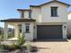 Two story home featuring neutral stucco, a two-car garage, covered entry, and red-tile roof in a suburban neighborhood at 3363 S 180Th Ln, Goodyear, AZ 85338