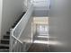 Bright foyer with carpeted stairs, white railing, wood-look floors and open sight lines to a living space at 3363 S 180Th Ln, Goodyear, AZ 85338