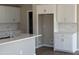 Kitchen featuring white cabinets, tile backsplash, quartz countertops and stainless faucet with wood-look floors at 3363 S 180Th Ln, Goodyear, AZ 85338
