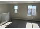Neutral carpeted loft with white railing, and a view of the surrounding neighborhood through the large windows at 3363 S 180Th Ln, Goodyear, AZ 85338