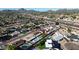 Scenic aerial view highlights residential homes with sparkling swimming pools, mature trees, and a nearby highway for easy commuting at 3444 E Paradise Dr, Phoenix, AZ 85028