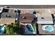 Bird's-eye perspective highlights homes with private pools, landscaped yards, and adjacent parking areas at 3444 E Paradise Dr, Phoenix, AZ 85028