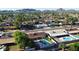 Expansive aerial view of a neighborhood featuring single-Gathering homes, lush landscaping, and a backdrop of stunning mountain views at 3444 E Paradise Dr, Phoenix, AZ 85028