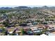 High-angle aerial view features a residential neighborhood with private pools, easy highway access, and scattered trees at 3444 E Paradise Dr, Phoenix, AZ 85028