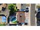 Overhead shot shows a house with a pool, green trees, a blue basketball court and a driveway with parked cars at 3444 E Paradise Dr, Phoenix, AZ 85028