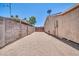 Low maintenance backyard features a full rockscape, surrounded by privacy walls and a wooden gate at 3444 E Paradise Dr, Phoenix, AZ 85028