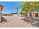 View of the backyard featuring decorative rock, a pool, tall palm tree, and a storage shed at 3444 E Paradise Dr, Phoenix, AZ 85028