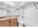 Bright bathroom featuring a single sink vanity, mirror, and a shower-tub combo at 3444 E Paradise Dr, Phoenix, AZ 85028