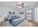 Comfortable bedroom features hardwood floors, ceiling fan, stylish decor, and lots of natural light at 3444 E Paradise Dr, Phoenix, AZ 85028