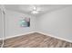 This bedroom features hardwood flooring, ceiling fan and a large window offering plenty of natural light at 3444 E Paradise Dr, Phoenix, AZ 85028