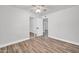 Bright bedroom featuring wood flooring, ample closet space, and a ceiling fan for added comfort at 3444 E Paradise Dr, Phoenix, AZ 85028