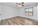 This bright bedroom features wood flooring and a large window, creating a warm, inviting space at 3444 E Paradise Dr, Phoenix, AZ 85028