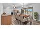 Spacious dining area featuring modern lighting and direct access to outdoor patio and pool at 3444 E Paradise Dr, Phoenix, AZ 85028