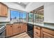 Kitchen view showing window, sink, cooktop and cabinets at 3444 E Paradise Dr, Phoenix, AZ 85028