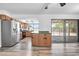 Kitchen with stainless steel appliances, wood cabinets and adjacent dining area at 3444 E Paradise Dr, Phoenix, AZ 85028