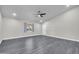 Bright living room features wood-look floors, a ceiling fan and a window at 3444 E Paradise Dr, Phoenix, AZ 85028