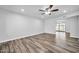 Spacious living room featuring wood-look tile flooring and a ceiling fan at 3444 E Paradise Dr, Phoenix, AZ 85028
