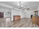 Open-concept living room with wood-look floors and a ceiling fan at 3444 E Paradise Dr, Phoenix, AZ 85028