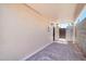 Covered patio with tile pavers, wall mount AC, a gate, and low maintenance yard at 3444 E Paradise Dr, Phoenix, AZ 85028