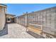 An outdoor patio features paver stones, a wooden bench, and a concrete block wall at 3444 E Paradise Dr, Phoenix, AZ 85028