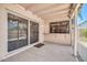 Covered patio with sliding glass door and window looking out to the backyard at 3444 E Paradise Dr, Phoenix, AZ 85028