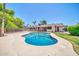 An inviting swimming pool with beautiful landscaping and mature trees at 3444 E Paradise Dr, Phoenix, AZ 85028