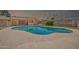 Fenced in in-ground pool, surrounded by an expansive deck and well-maintained landscaping at 3444 E Paradise Dr, Phoenix, AZ 85028