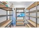 A well-organized storage room is equipped with shelving and a water heater for convenience at 3444 E Paradise Dr, Phoenix, AZ 85028