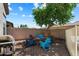 Inviting backyard with a cozy fire pit and colorful Adirondack chairs under a mature shade tree at 35414 N 32Nd Dr, Phoenix, AZ 85086