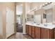 Inviting bathroom featuring a double vanity, and views to the exterior pool area at 35414 N 32Nd Dr, Phoenix, AZ 85086