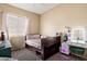 This bedroom features neutral walls, soft carpet, window, and modern furniture at 35414 N 32Nd Dr, Phoenix, AZ 85086