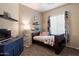 This bedroom has carpeted floors, a ceiling fan, and decor at 35414 N 32Nd Dr, Phoenix, AZ 85086