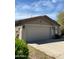 A home's exterior showcases a two-car garage with a neutral color, complemented by desert landscaping at 35414 N 32Nd Dr, Phoenix, AZ 85086