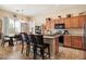 Open kitchen with dark wood cabinets, an island with bar stools, and tile flooring at 35414 N 32Nd Dr, Phoenix, AZ 85086