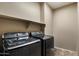 Bright laundry room features a shelving unit, and front loading washer and dryer appliances at 35414 N 32Nd Dr, Phoenix, AZ 85086