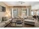 Spacious living room featuring multiple couches, a ceiling fan, and decorative elements at 35414 N 32Nd Dr, Phoenix, AZ 85086