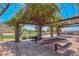 Shaded community picnic area with picnic tables, concrete floor and mature landscaping on a bright sunny day at 35414 N 32Nd Dr, Phoenix, AZ 85086