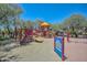 Community playground with slides, climbing structures and soft padded ground cover is surrounded by mature shade trees at 35414 N 32Nd Dr, Phoenix, AZ 85086