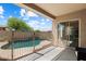 Covered patio view of a private backyard swimming pool enclosed by a safety fence for peace of mind at 35414 N 32Nd Dr, Phoenix, AZ 85086