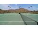 Well-maintained tennis court amidst desert scenery offering recreational fitness and community engagement at 35414 N 32Nd Dr, Phoenix, AZ 85086