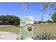 Sign at Tramonto Park with grassy areas and trees showing park rules and access information at 35414 N 32Nd Dr, Phoenix, AZ 85086