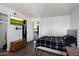 A tidy bedroom includes stylish hardwood floors, a TV, closet and a comfortable bed at 3551 N 12Th St # 101, Phoenix, AZ 85014