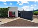 An exterior shot showing the home's unique architectural design with a desert landscape and vibrant greenery at 3551 N 12Th St # 101, Phoenix, AZ 85014