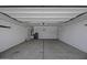 Spacious two-car garage with concrete floors and white walls at 36602 W San Alvarez Ave, Maricopa, AZ 85138
