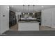 Modern kitchen with granite countertops, an island with a sink, and stainless steel appliances, perfect for cooking enthusiasts at 36602 W San Alvarez Ave, Maricopa, AZ 85138
