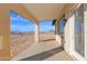 Covered back patio with desert landscape at 37504 W Elm Ave, Tonopah, AZ 85354