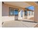 Covered back patio with tan columns and a view of the backyard at 37504 W Elm Ave, Tonopah, AZ 85354