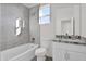 Bathroom featuring tiled shower-tub and granite countertops at 37504 W Elm Ave, Tonopah, AZ 85354
